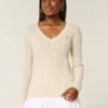 Jersey de cuello en V con diseño icónico de punto trenzado
