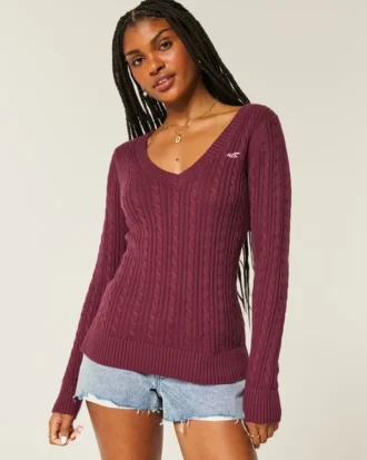 Jersey de cuello en V con diseño icónico de punto trenzado