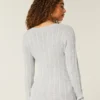 Jersey de cuello en V con diseño icónico de punto trenzado