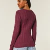 Jersey de cuello en V con diseño icónico de punto trenzado
