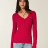 Jersey icónico de cuello en V con tejido de punto trenzado