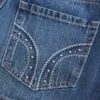 Minifalda pantalón vaquera con tachuelas y talle bajo
