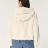 Sudadera con capucha y cremallera de pelo sintético