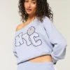 Sudadera con gráfico NYC y hombros descubiertos