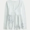 Top babydoll de manga larga con estampado gráfico en el pecho