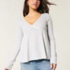 Top babydoll de manga larga con punto calado