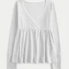 Top babydoll de manga larga con punto calado