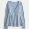 Top babydoll de manga larga con punto calado