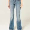 Vaqueros bootcut de talle bajo, lavado medio y efecto desgastado