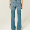 Vaqueros bootcut de talle bajo y lavado medio con tachuelas