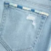 Vaqueros bootcut rasgados de lavado claro y talle bajo con bordados
