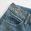 Vaqueros holgados con cintura bordada, lavado medio y talle ultra bajo Vaqueros holgados con cintura bordada, lavado medio y talle ultra bajo